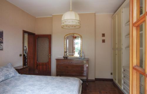 a bedroom with a bed and a mirror and a dresser at Awesome Home In Cingoli With Wifi in Cingoli