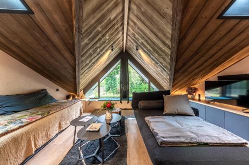 a room with two beds and a couch and a table at Le Grenier sur l'Eau -5 étoiles- Saint-Malo in Saint Malo