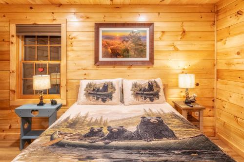 a bedroom with a bed with three owls on it at Real Log Cabin With Amazing Views, Hot Tub, Sauna, Games in Gatlinburg