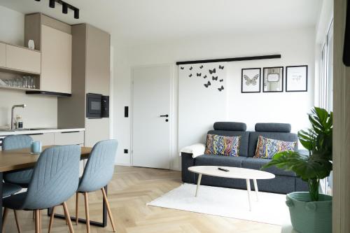 a living room with a blue couch and a table at SI apartments - Smart Inn in Vienna