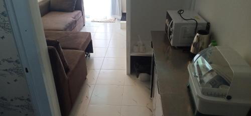 a living room with a couch and a tile floor at VicaWorld in Prathai