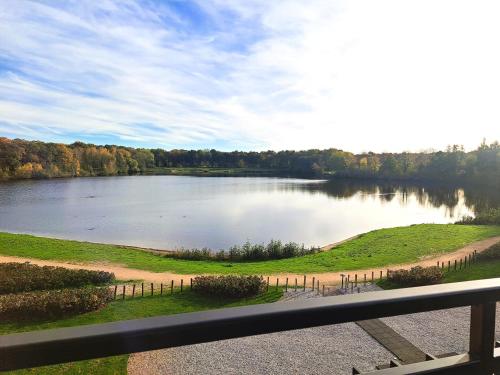 a view of a lake from a balcony at Parkhotel Horst - Venlo in Horst