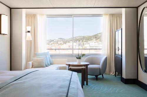 a hotel room with a bed and a window at Mondrian Cannes in Cannes
