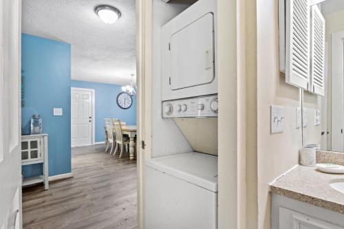 a kitchen with white appliances and a dining room at Dry Dock 101 in Myrtle Beach