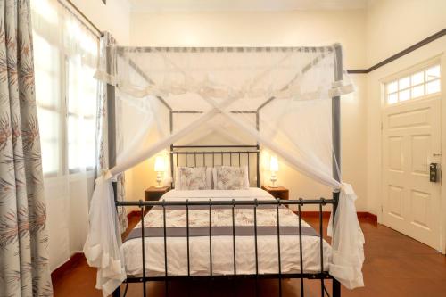 a bedroom with a bed with a canopy at Masindi Hotel in Masindi