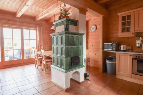 a kitchen with a stove in the center of a room at 1A Chalet Koralpenglück Wandern, Grillen und Indoor Sauna in Elsenbrunn