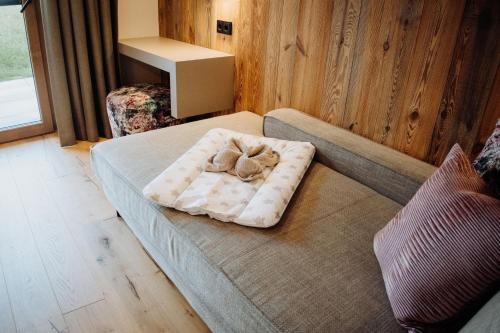 a teddy bear sitting on a bed in a room at Biohof Ebengut in Maria Alm am Steinernen Meer