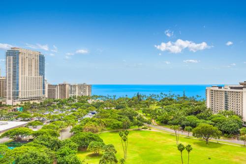 an aerial view of a city with palm trees and the ocean at Luana Waikiki Hotel & Suites in Honolulu