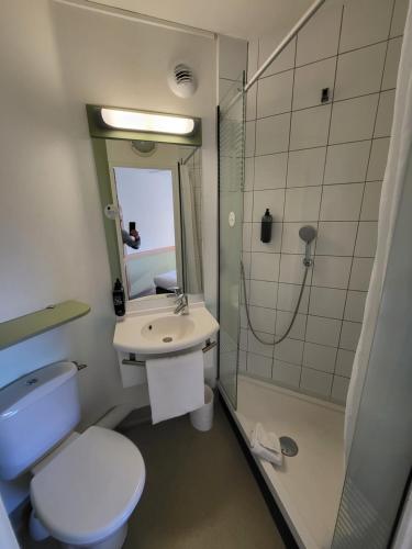 a bathroom with a toilet and a sink and a shower at Ibis Budget Marseille Valentine in Marseille