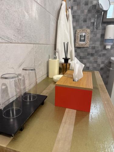 a bathroom with two glasses on a counter at BEBIRGU PALAZZINO LUXURY 2 jacuzzi to share in Vittoriosa