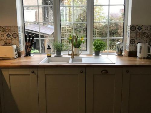 a kitchen counter with a sink and a window at Cosy Cottage in Medieval Conwy with garden and parking in Conwy