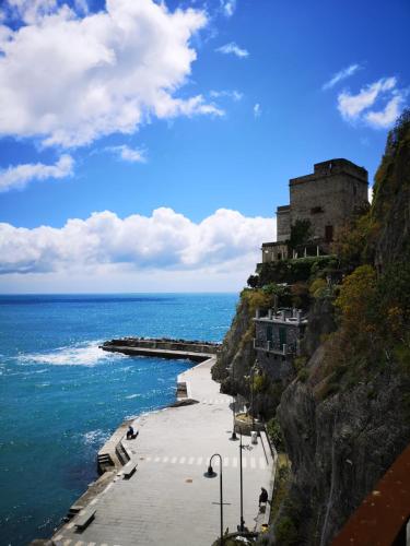 a castle on a cliff next to the ocean at La Rosa Dei Venti in Monterosso al Mare