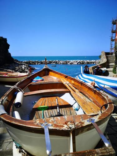 a boat is docked on a dock in the water at La Rosa Dei Venti in Monterosso al Mare