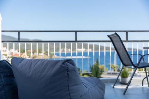 a couch and a chair on a balcony at Mikelanna Aegean Skyline in Neos Marmaras
