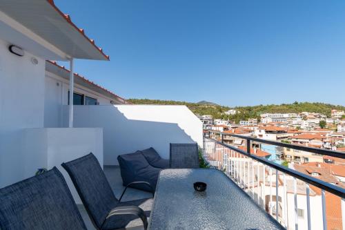 a balcony with two chairs and a table at Mikelanna Aegean Skyline in Neos Marmaras