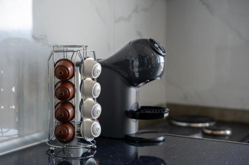 a glass vase with chocolate covered eggs and a mixer at Mikelanna Aegean Skyline in Neos Marmaras