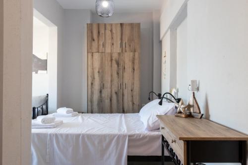 a bedroom with a bed with a wooden headboard at Mikelanna Aegean Skyline in Neos Marmaras