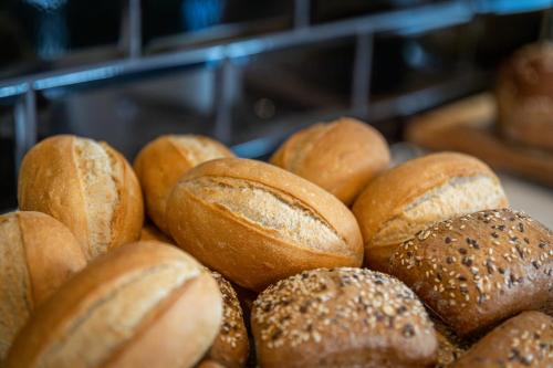 a pile of loaves of bread sitting on a table at Parkhotel Horst - Venlo in Horst