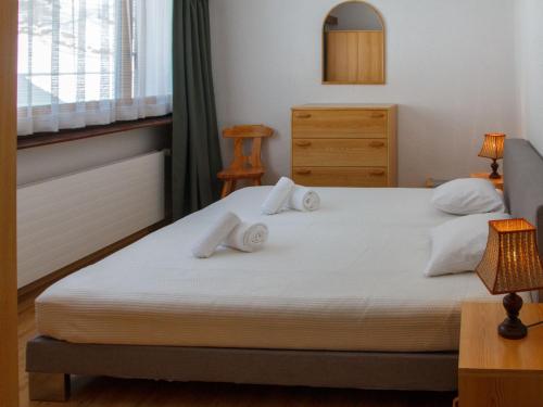 a bedroom with a bed with two pillows on it at Apartment Rosablanche A21 by Interhome in Siviez