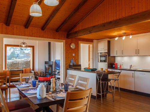 a kitchen and dining room with a table and chairs at Chalet Beke by Interhome in Nendaz
