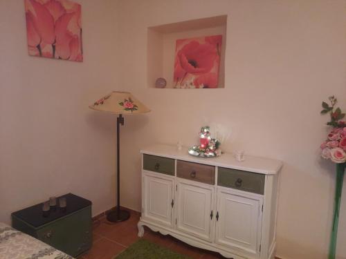 a room with a white cabinet and a lamp at Bačalandia- relax na samote in Veľká Dolina