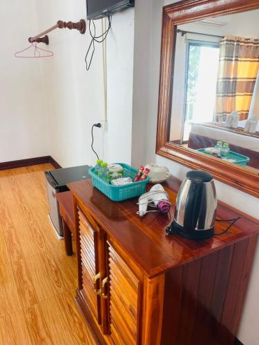 a room with a wooden desk with a mirror at Vang Vieng Global Hostel in Vang Vieng