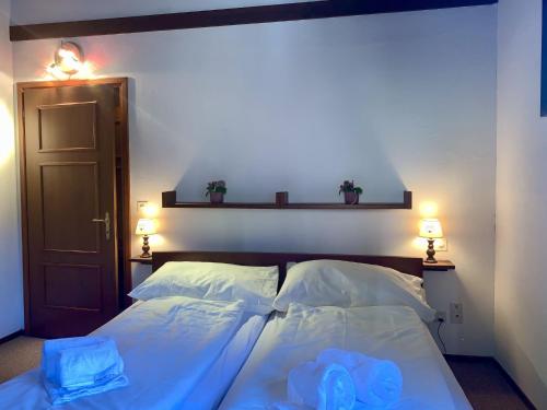 a bedroom with a bed with two blue towels on it at Apartment Residenza Chesa Margun 59-6 by Interhome in Surlej