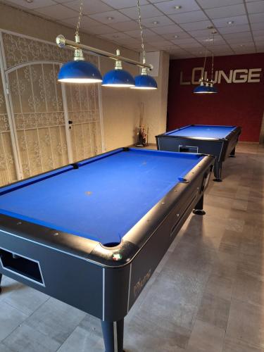 two pool tables in a billiard room with blue lights at Apartment Morgengruß - Pool & Sauna in Hohegeiß