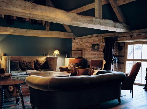 a living room with a couch and a table at St Giles House Accommodation in Wimborne Saint Giles