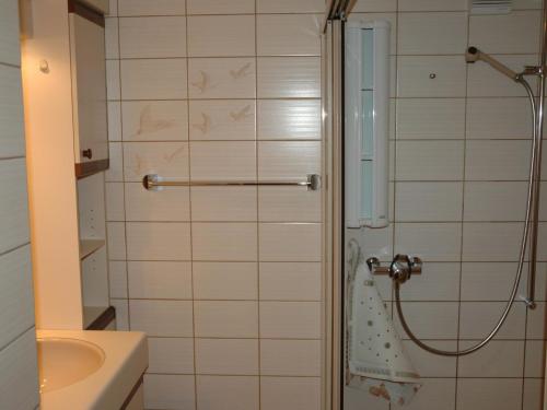 a bathroom with a shower and a sink at Apartment Bärgchutzli Parterre by Interhome in Adelboden