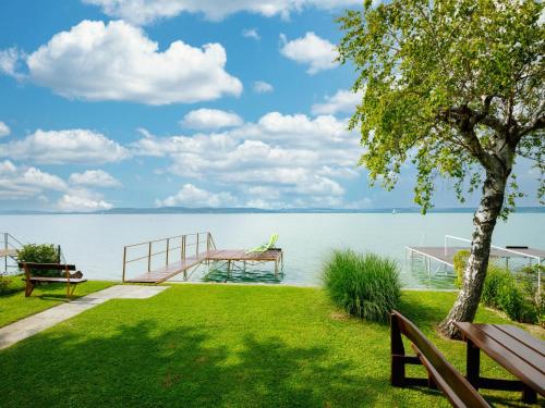 a park with benches and a view of the water at Holiday Home Hanna by Interhome in Balatonlelle