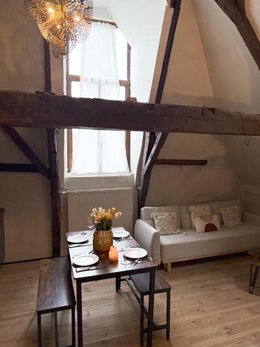 a living room with a table and a couch at LouLou Home's in Antwerp