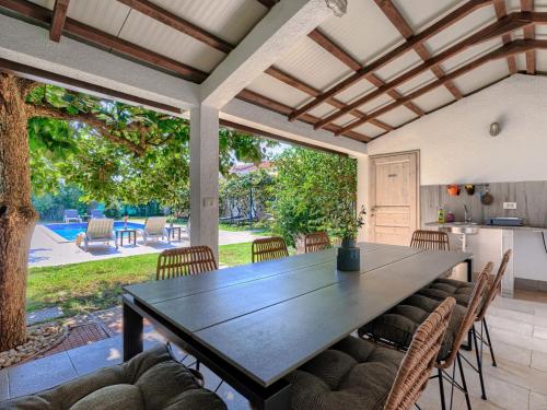 a dining room with a table and chairs at Holiday Home Villa Toni by Interhome in Umag