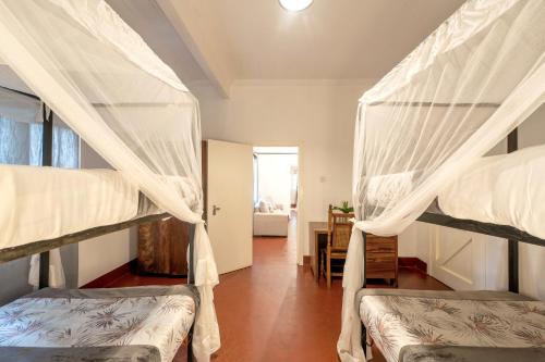 two bunk beds in a room with a hallway at Masindi Hotel in Masindi