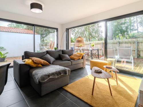 un salon avec un canapé et une grande fenêtre dans l'établissement Holiday Home palot 17 by Interhome, à Mimizan