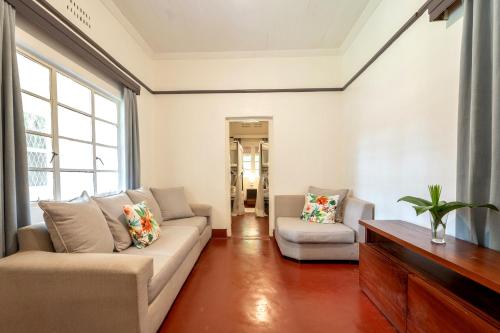 a living room with a couch and two chairs at Masindi Hotel in Masindi