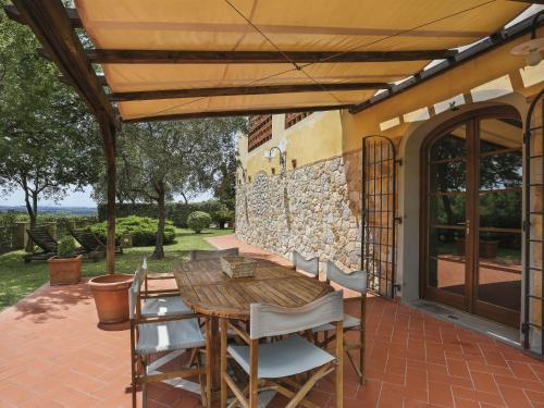 a wooden table and chairs on a patio at Holiday Home Desideri by Interhome in Fornello