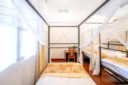a bedroom with two bunk beds and a window at Masindi Hotel in Masindi