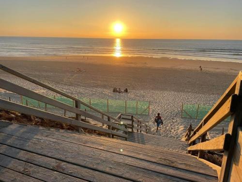 a view of a beach at sunset with the sun setting at Holiday Home Laouchet by Interhome in Pontenx-les-Forges