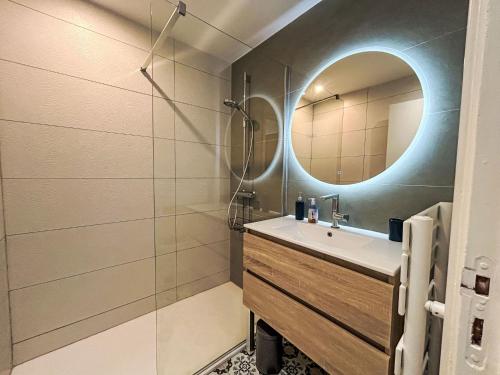 a bathroom with a sink and a mirror at Apartment Les Alizés-1 by Interhome in Carnac-Plage