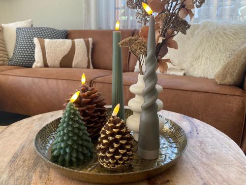 a table with three christmas trees and candles on it at Apartment Alpenrose by Interhome in Adelboden