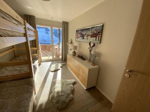 a room with a bedroom with a bunk bed at Apartment Alpenrose by Interhome in Adelboden