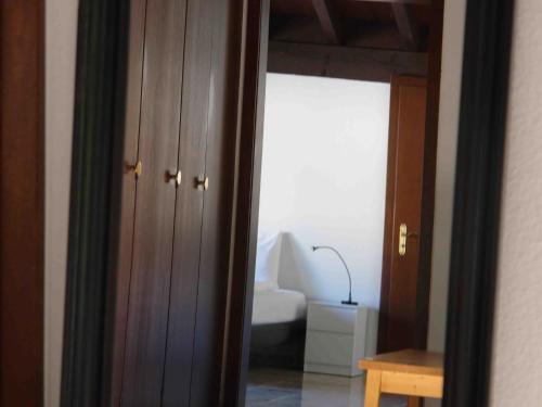 a room with a bedroom with a bed and a mirror at Apartment Près du Bahnhof by Interhome in Engelberg