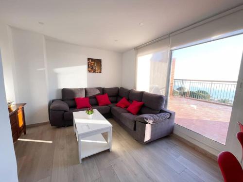 a living room with a couch and a table at Ático con terraza en La Pineda in La Pineda