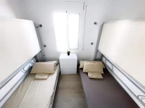 a small room with two benches and a window at Ático con terraza en La Pineda in La Pineda
