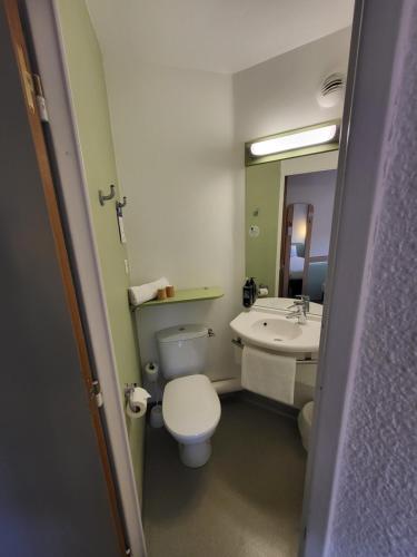 a bathroom with a toilet and a sink at Ibis Budget Marseille Valentine in Marseille