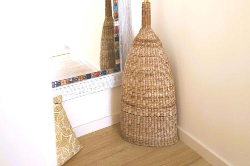 a room with two large baskets on the wall at Fonte do Cabo Apartment in Ericeira