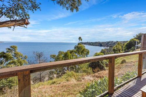 a view of the ocean from the deck of a house at Lakescapes Cottage in Metung