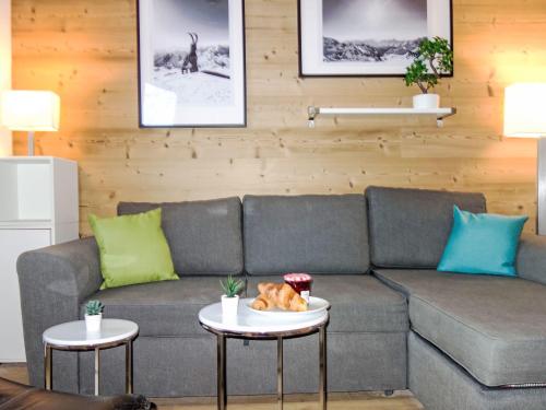 a living room with a couch and two tables at Apartment Nazca I6 by Interhome in Val Thorens
