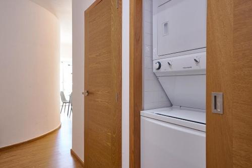 a kitchen with a white stove and a dishwasher at Armonia 24 suites by Yellowkey in Los Prados